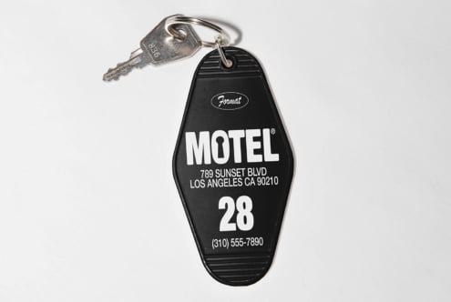 Motel keychain with vintage style design featuring room number 28 and contact details. Ideal for graphic design mockups and retro-themed templates.