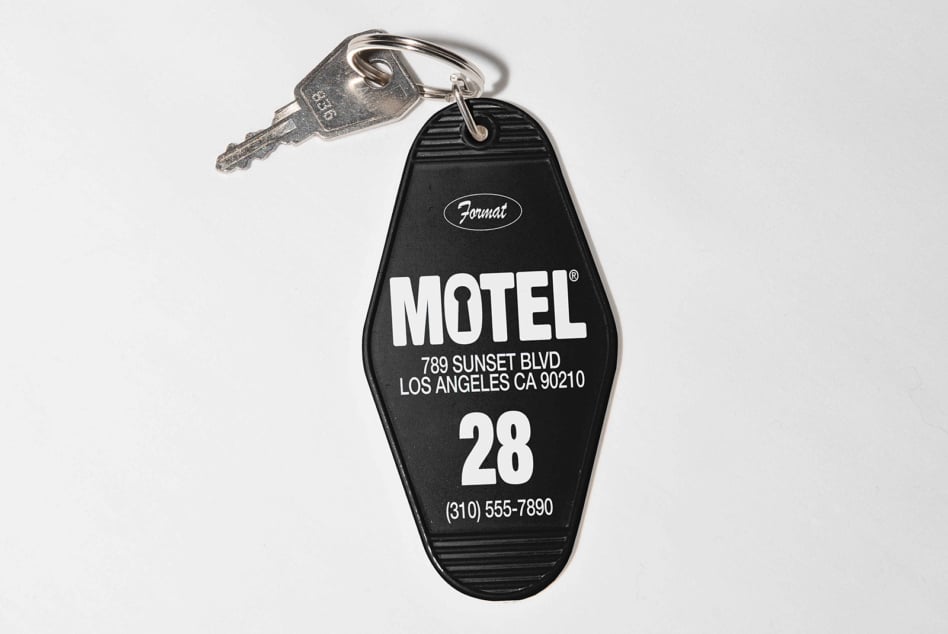 Vintage motel key with silver metal tag labeled Motel room 28