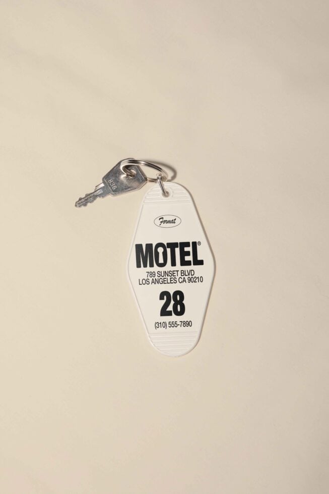 Vintage motel keychain mockup for designers featuring a beige background ideal for graphic design templates branding and retro-themed projects.