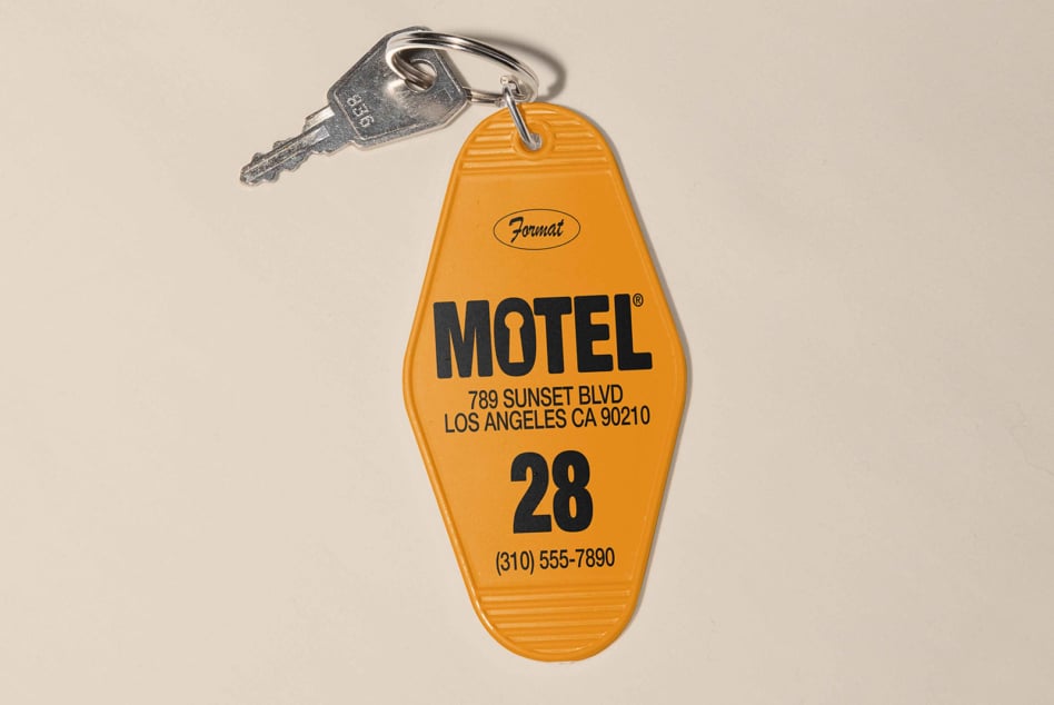 Bright yellow retro motel key tag with bold black lettering
