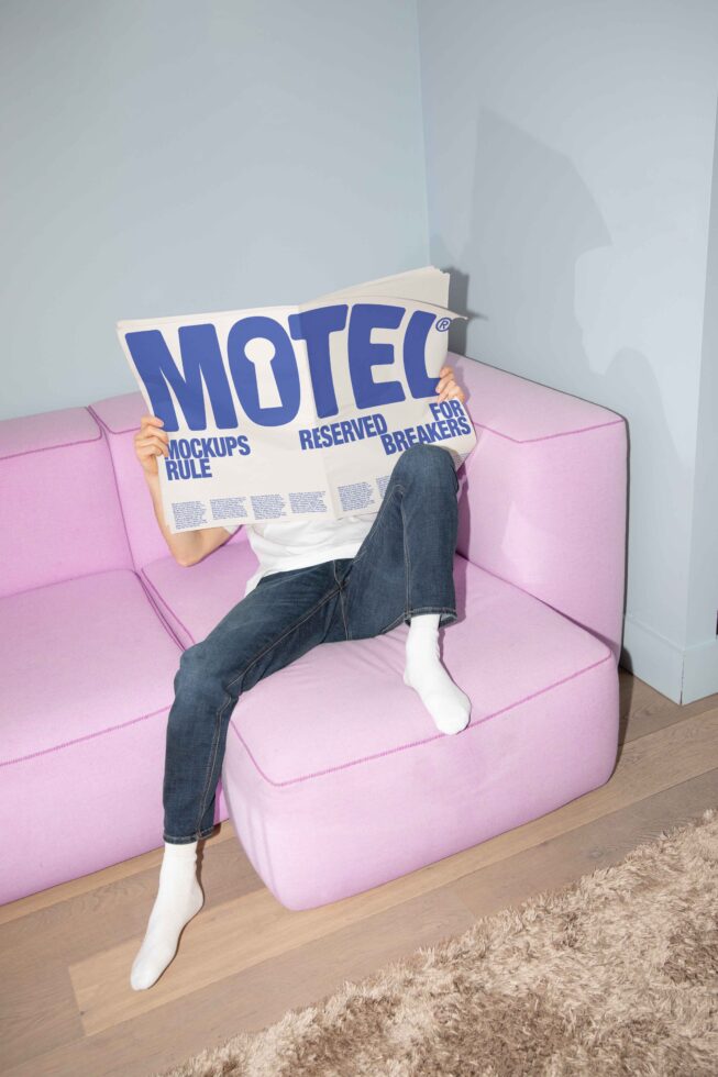Person sitting on pink couch holding a newspaper titled MOTEC Mockups. Ideal for design mockups, home decor templates, interior design graphics.