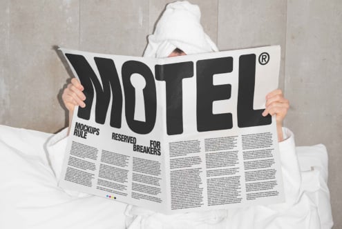 Person in a white robe reads newspaper in bed. Headline says MOTEL. Design mockup for showcasing editorial layouts. Keywords: Mockups, Templates, Designers