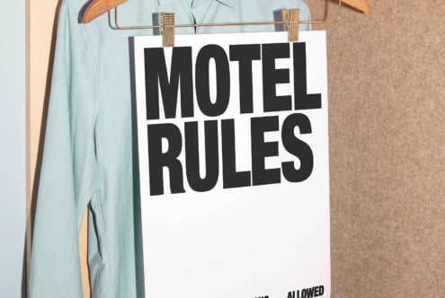 Motel rules poster mockup hanging on a mint green shirt in a closet ideal for showcasing graphic designs templates with bold typography SEO friendly