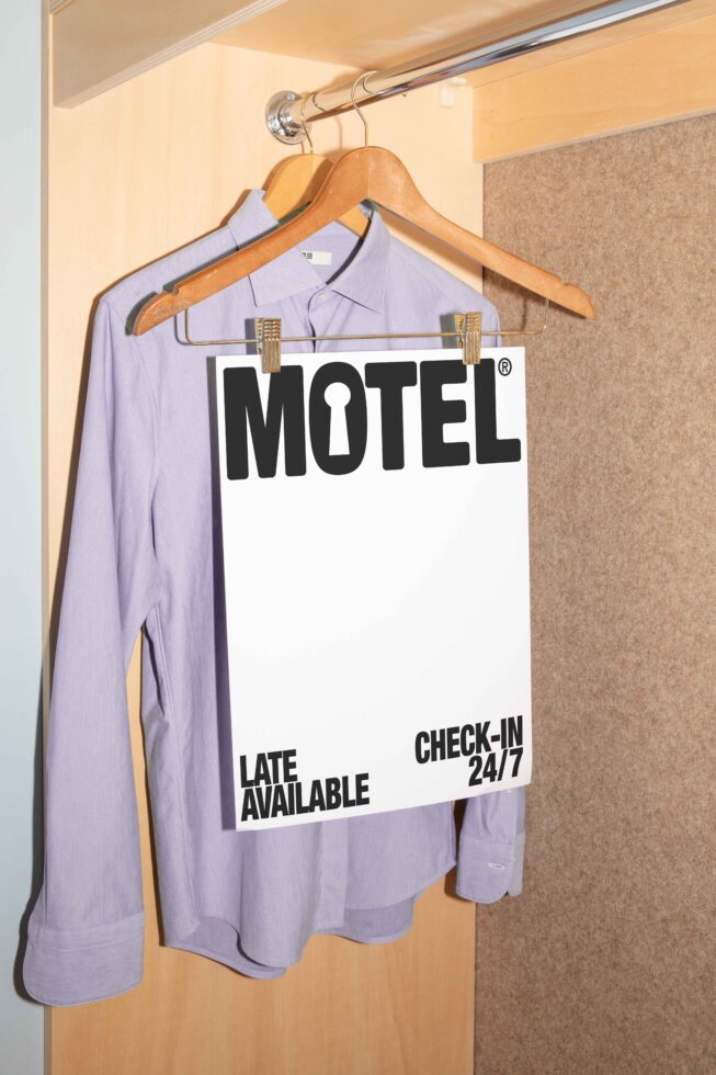 Mockup showcasing a white sheet with bold Motel text on a hanger with a shirt in a wardrobe. Ideal for designers seeking print templates or graphics.