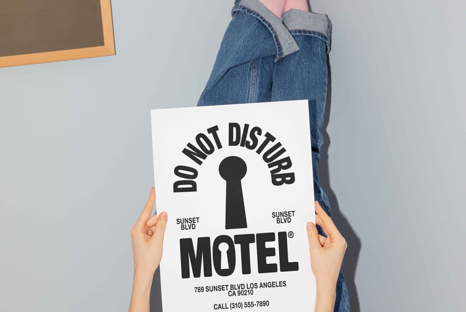 Hands holding do not disturb motel mockup with keyhole symbol Los Angeles address