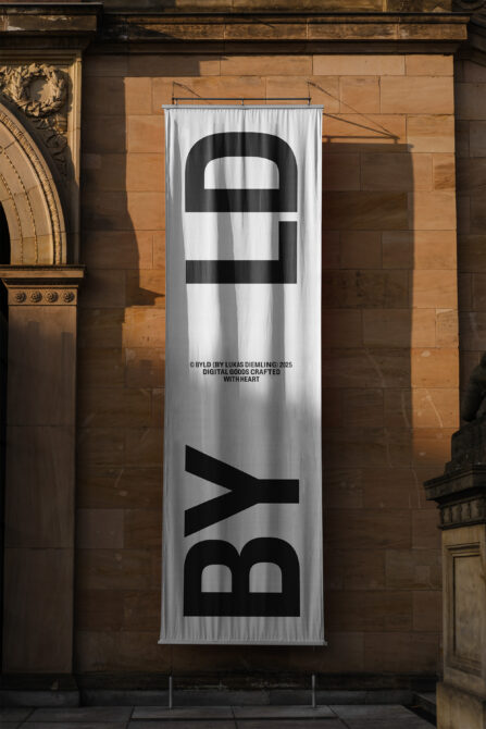 Tall banner with bold black striped logo on white fabric hanging on brick wall
