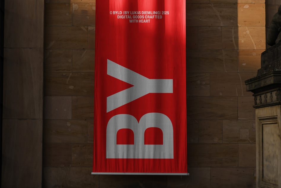 Bright red vertical banner with silver geometric shapes displayed on stone building