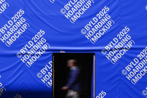 Hoarding mockup showcasing blurred person walking against a blue backdrop with branding text. Perfect for designers looking for realistic mockup templates.