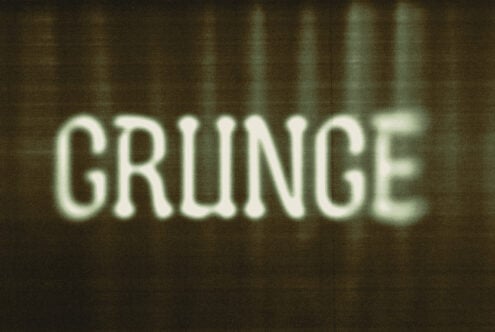Blurred text reading grunge with a textured background. Grunge font style perfect for designers seeking vintage or retro vibes in graphics projects.