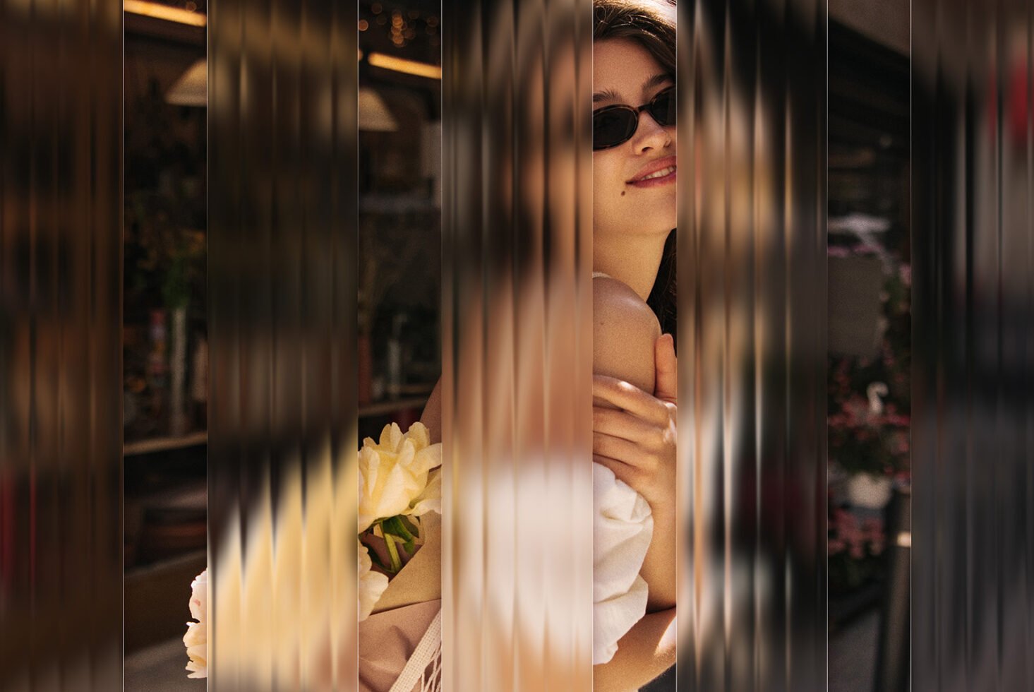 Stylish woman outdoors with flowers obscured by distorted vertical lines. Modern artistic photo for fashion templates. Ideal for graphic design projects.