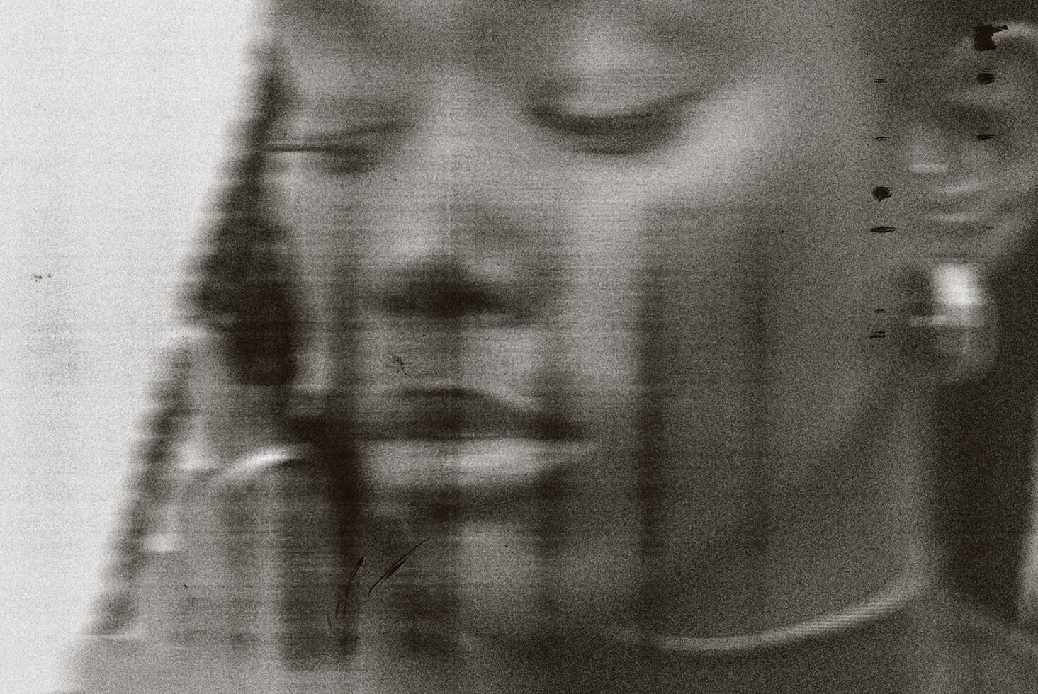 Abstract black and white portrait with blurred elements showing a serene face. Perfect for graphic design, photo manipulation, artistic template use.