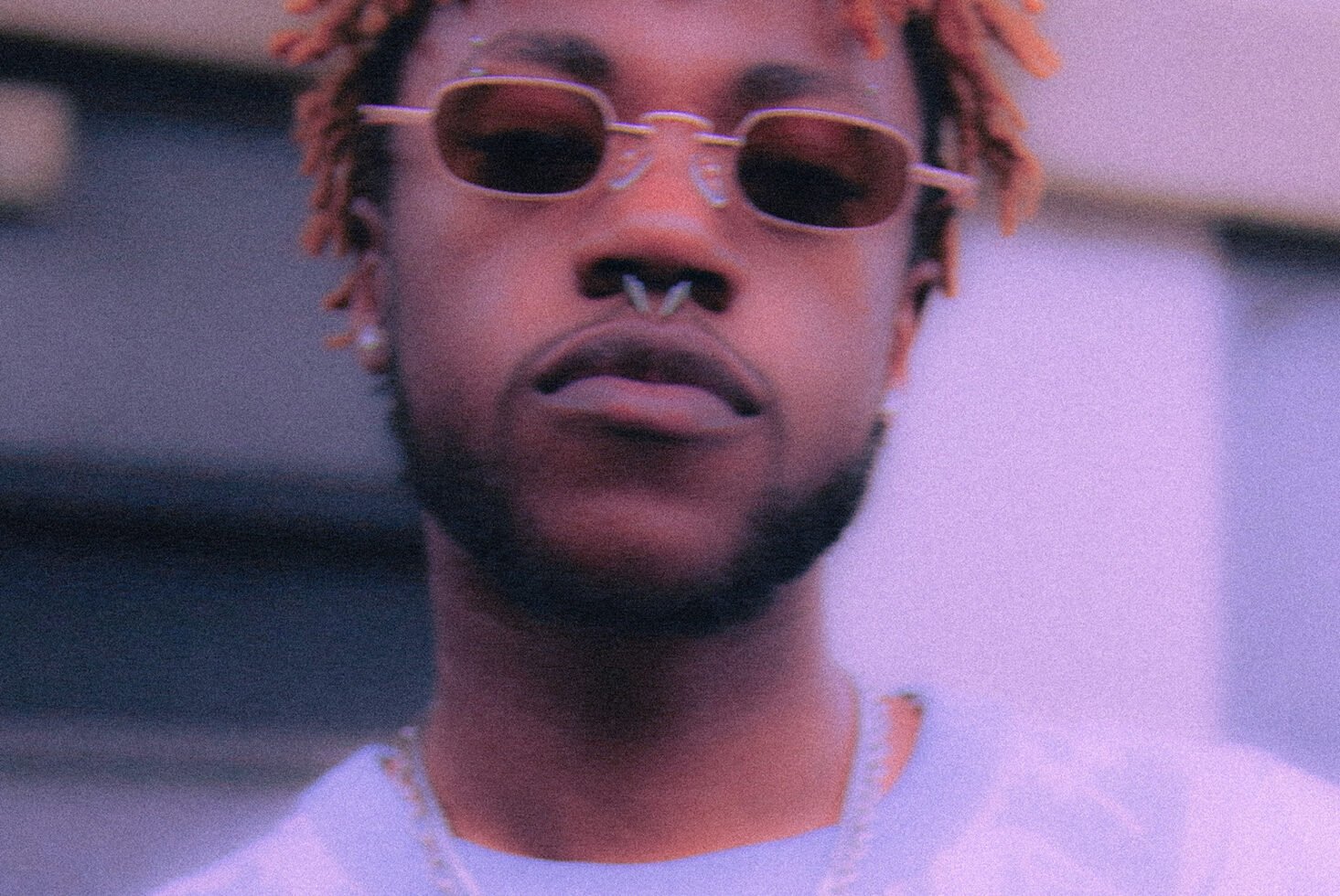 Stylish man with sunglasses and septum piercing in a close-up shot. Perfect for fashion design, urban graphics, hipster mockups, creative templates.