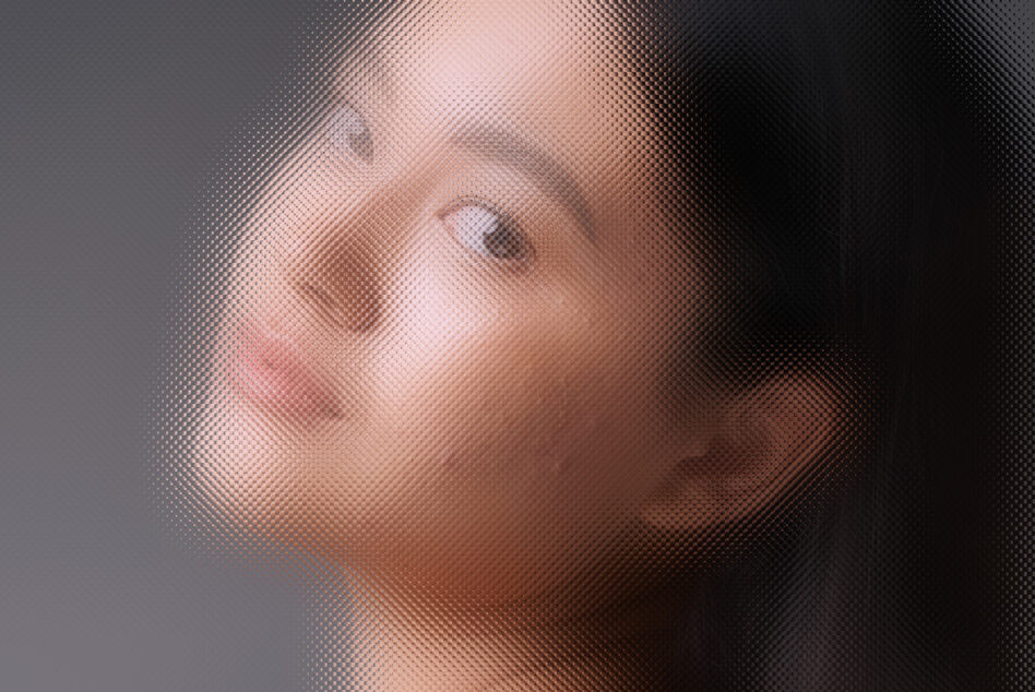Soft portrait rendered in fine halftone dot pattern fading from light to dark