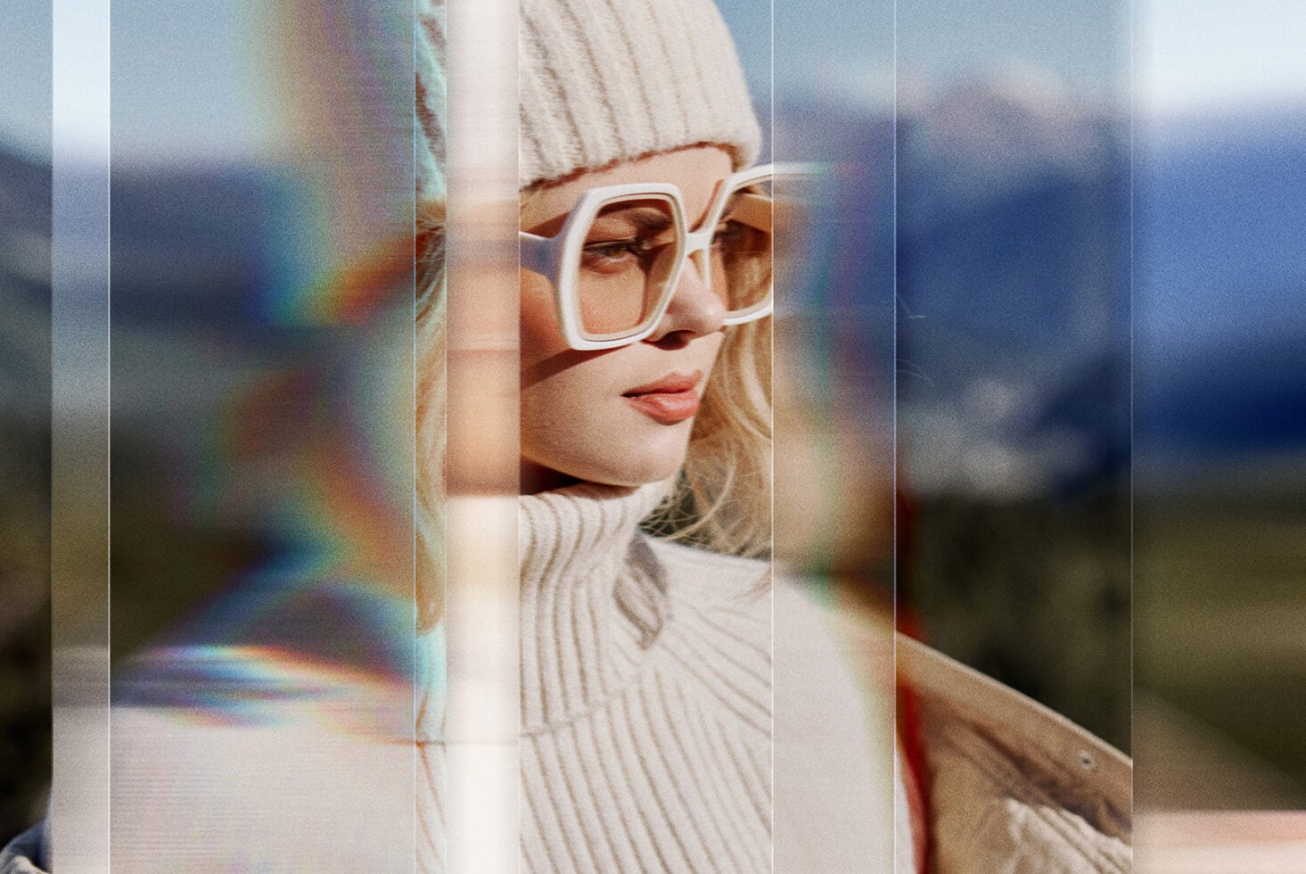 Woman in white beanie wearing cream-colored sunglasses with prism light leak overlay