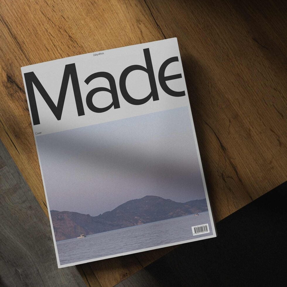 Magazine mockup on wooden table showcasing a minimalist cover with landscape photo ideal for graphic designers enhancing portfolio presentation.