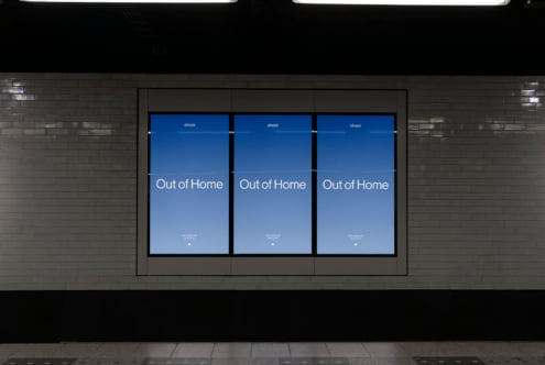 Digital billboard mockup in a subway station with blue gradient background displaying Out of Home text suitable for advertising and graphic projects.