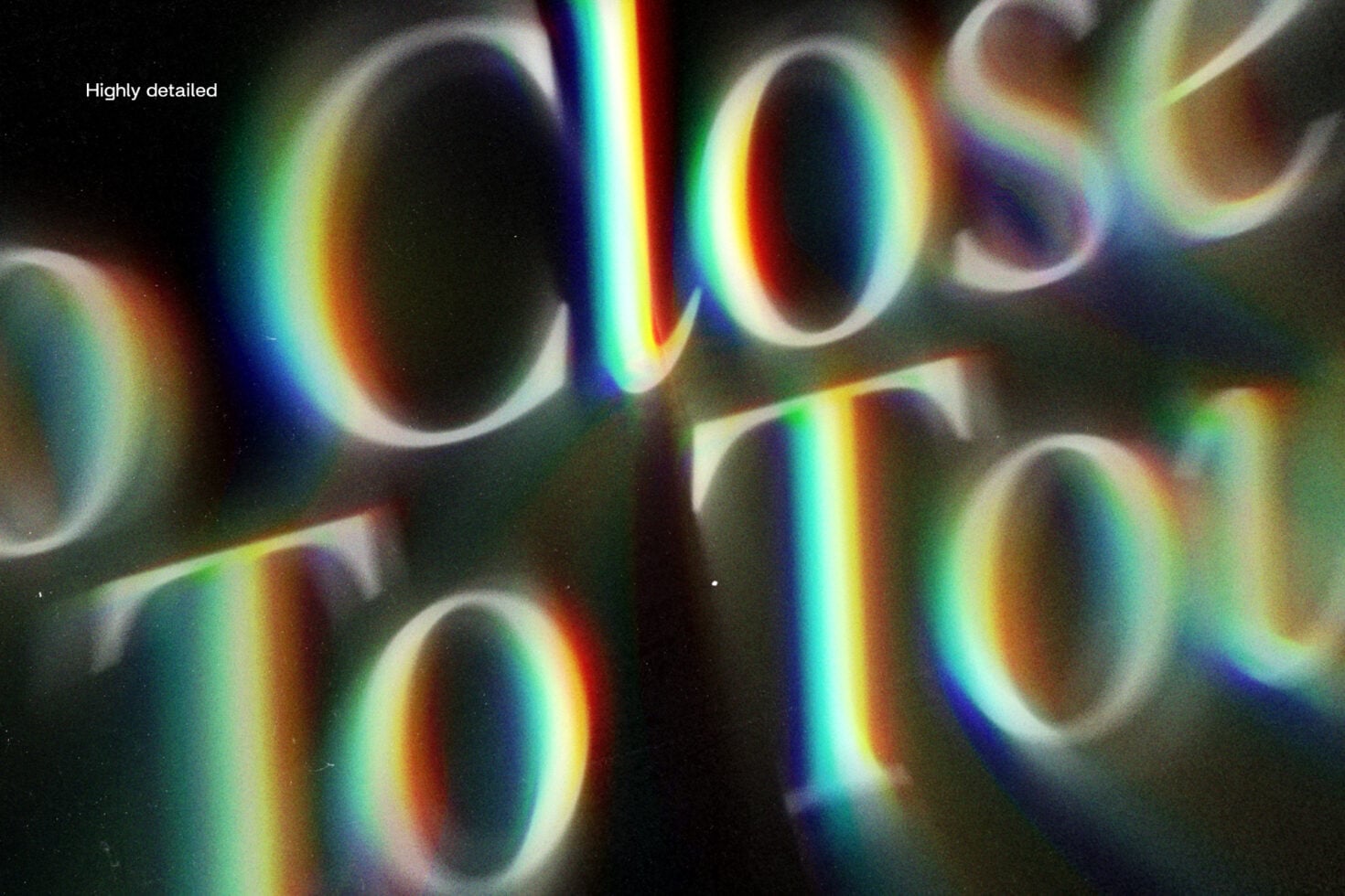 Close-up macro shot of blurred letters with colorful light refraction streaks