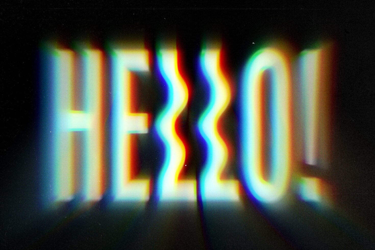 HELLO text with neon chromatic aberration colors glitching on dark background