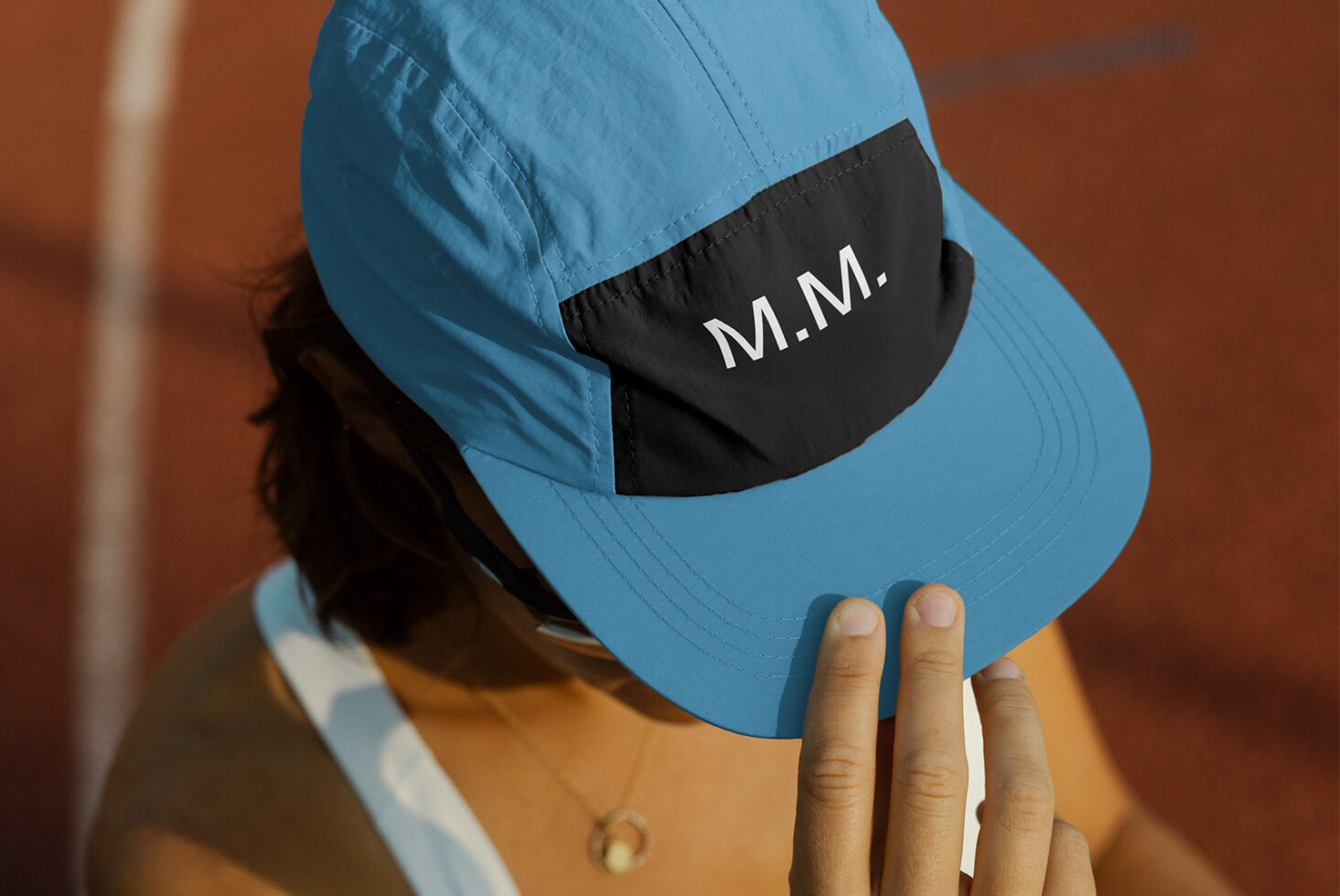 Blue sports cap mockup with black front panel displaying text. Ideal for branding and logo designs. High-quality accessory template for designers.