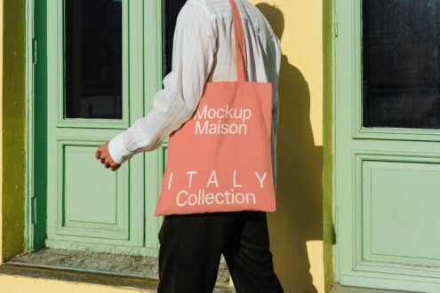 Tote bag mockup with coral design Italy Collection text perfect for showcasing graphic designs or branding near green door ideal for designers seeking templates.