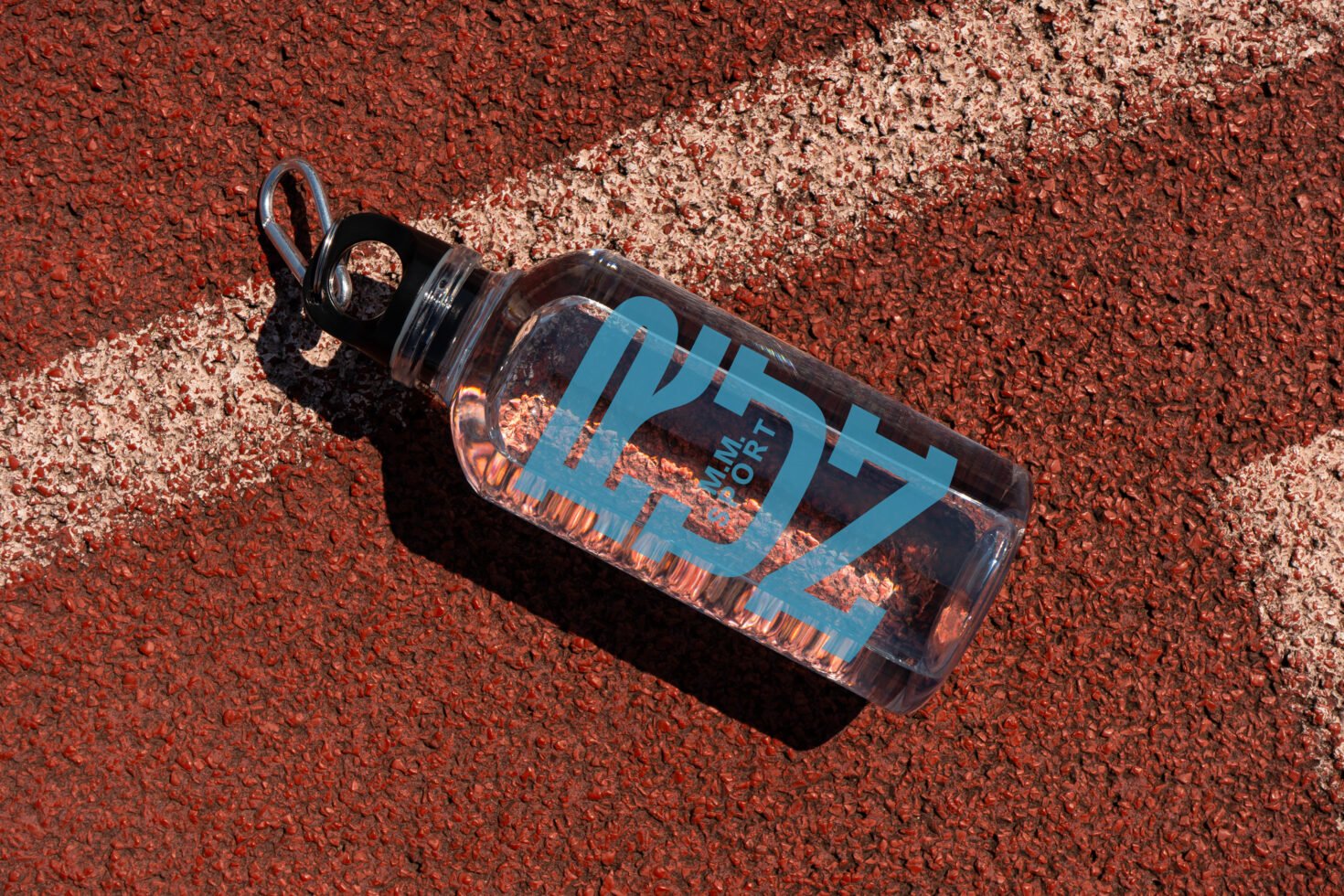 Clear water bottle mockup with blue text on a red athletic track featuring a white line. Ideal for showcasing custom branding and design templates.