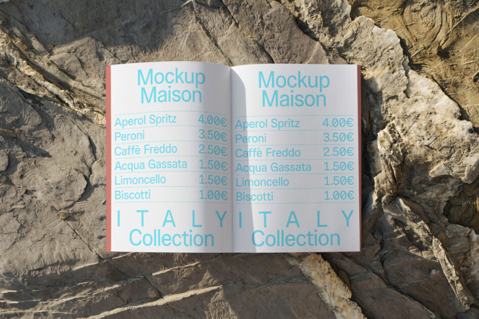Open menu spread on rocky cliff showing drinks, prices, Italy Collection branding