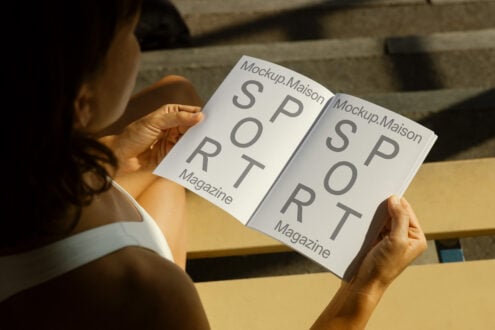 Person holding open magazine mockup featuring large text Sport on each page perfect for design presentations and showcasing editorial templates