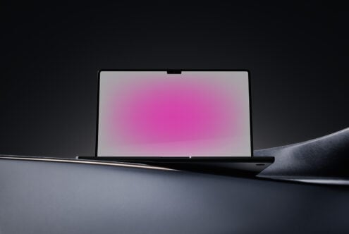 Laptop mockup with pink gradient screen and dark background suitable for digital asset marketplaces targeting designers and creatives seeking templates.