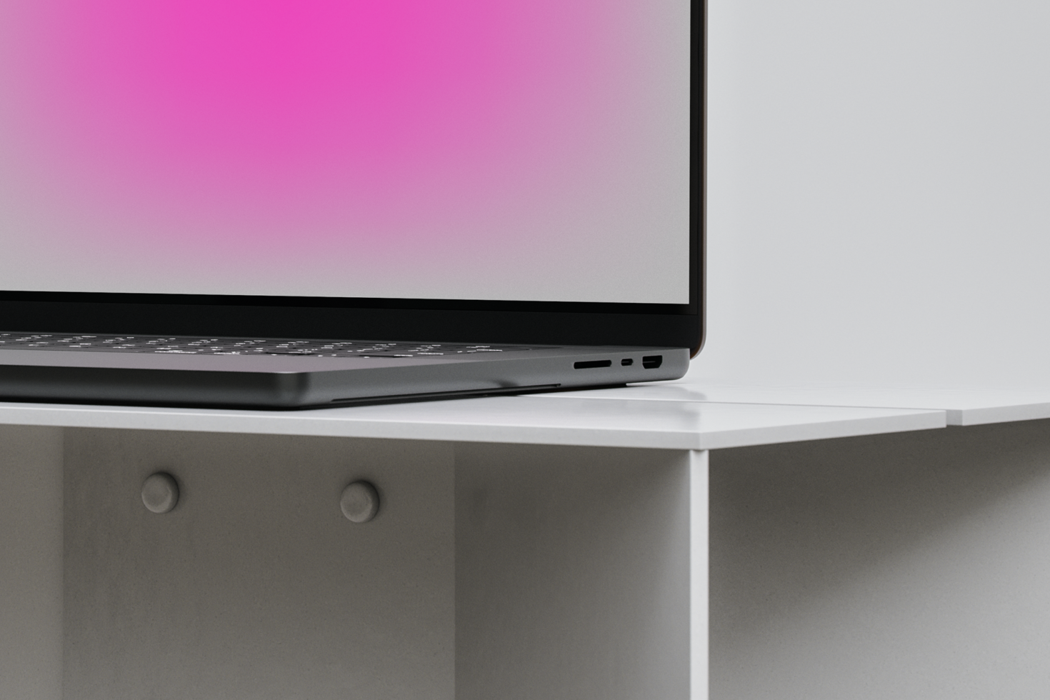 Laptop mockup on white desk with pink screen gradient suitable for designers featuring minimalistic tech design perfect for digital assets and templates.