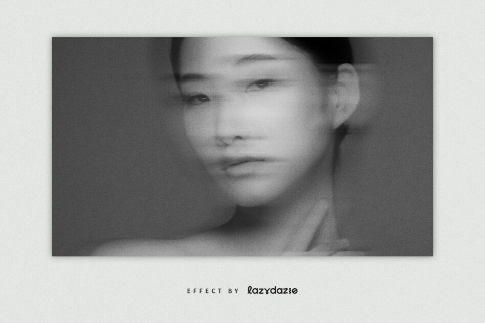 Soft focus portrait of woman looking down, grayscale blur effect