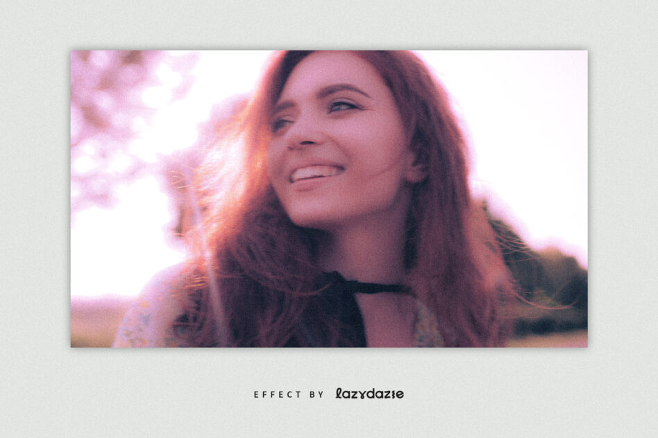 Person smiling outdoors with warm orange pink glow, soft dreamy film aesthetic