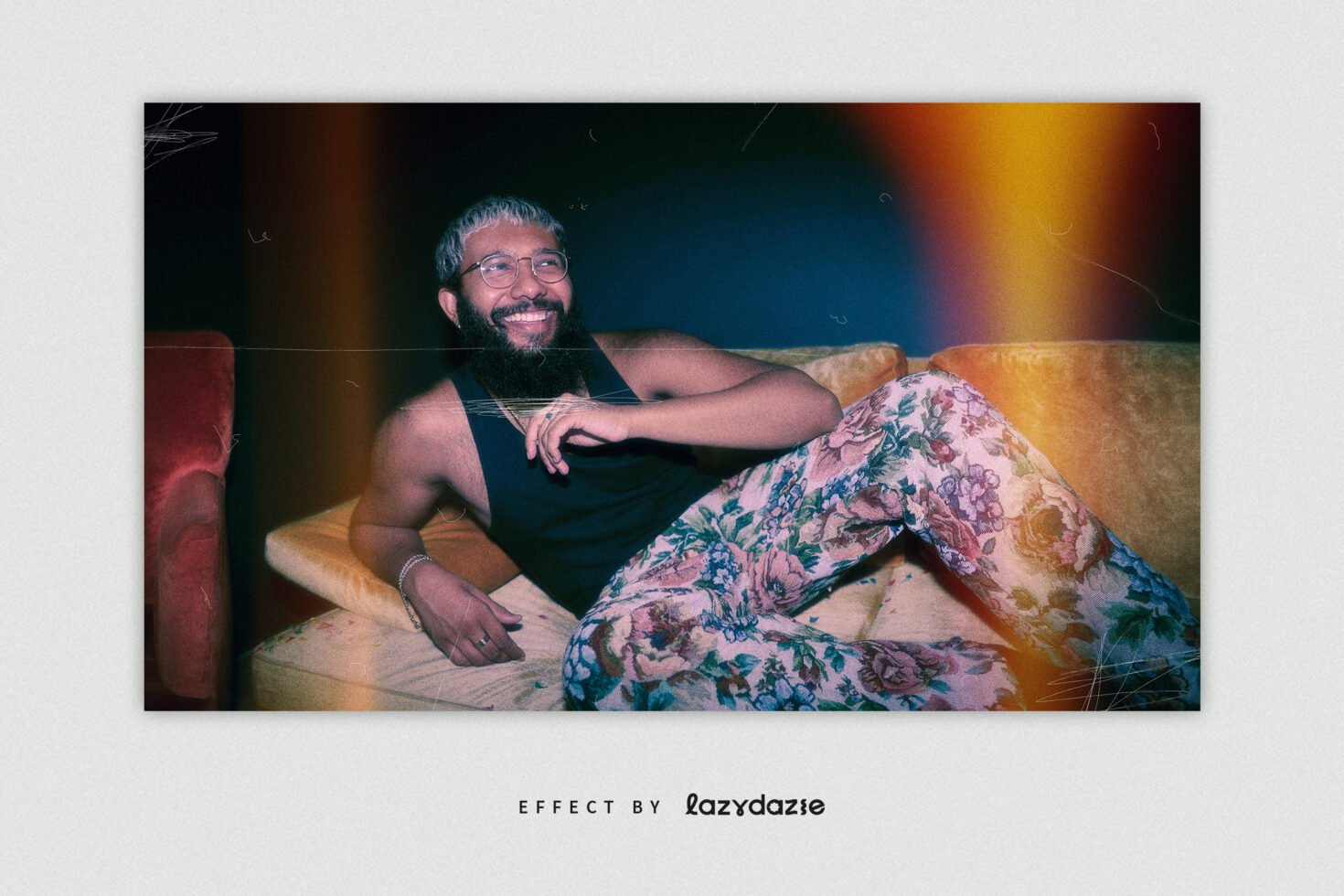 Man in floral pants on sofa with vintage filter. Retro design template. Perfect for creative projects. Vibrant colors and relaxed mood. Digital asset.