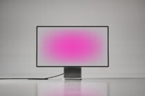 Minimalist computer monitor mockup with pink gradient screen isolated on white background perfect for graphic design digital assets and templates.