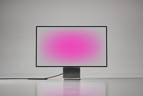 Minimalist computer monitor mockup with pink gradient screen isolated on white background perfect for graphic design digital assets and templates.