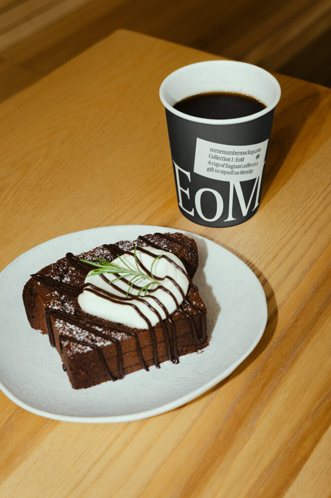 Coffee cup mockup on wooden table next to chocolate cake. Ideal for designers creating branding presentations or cafe menus. High-quality template.