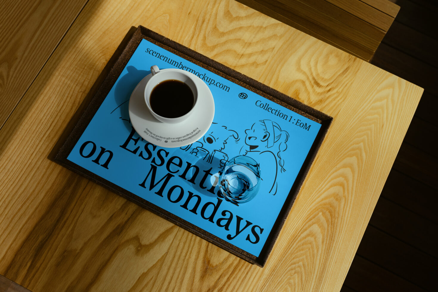 Blue poster with cartoon sketch and bold text reading Essential on Mondays placed on a wooden table with coffee cup and glass. Poster mockup for designers.
