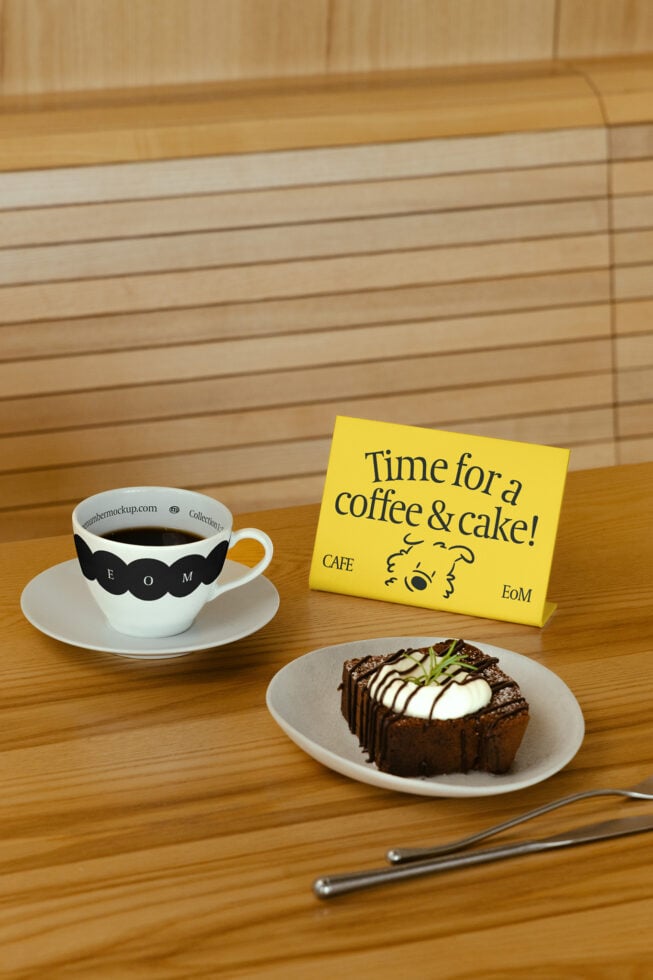 Coffee cup and cake on wooden table with sign reading Time for a coffee and cake Perfect for cafe graphics restaurant mockups or menu templates.