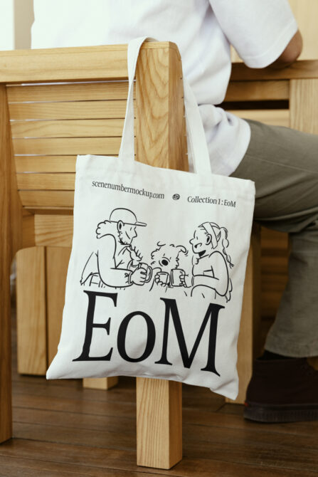 Off-white canvas tote with sketch illustration of people holding drinks, large EoM typography