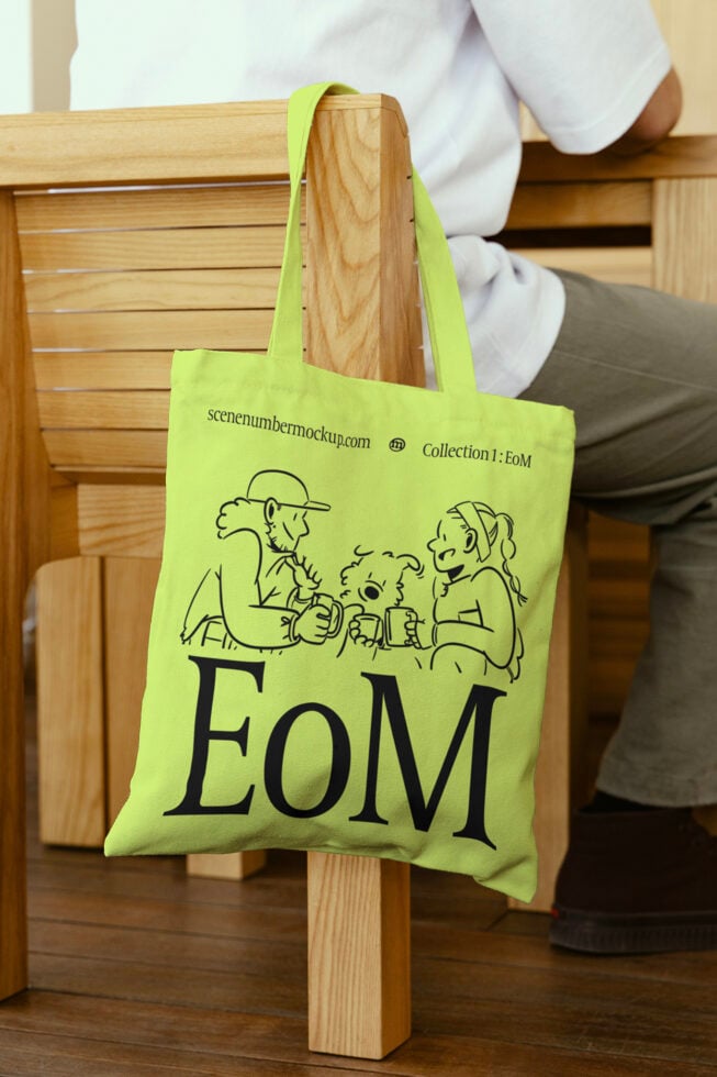Green tote bag with cartoon illustration and typography mockup. Ideal for designers seeking stylish tote bag graphics and customizable mockup templates.