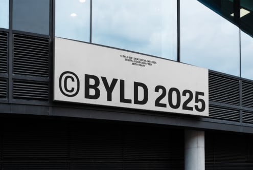 Modern building facade displaying © BYLD 2025 sign digital design template urban branding architecture mockup for graphic designers branding projects