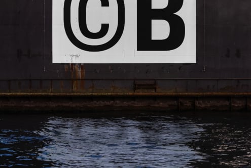 Industrial metal wall with bold black CB typography over water surface Digital asset for graphic designers Keywords typography industrial design