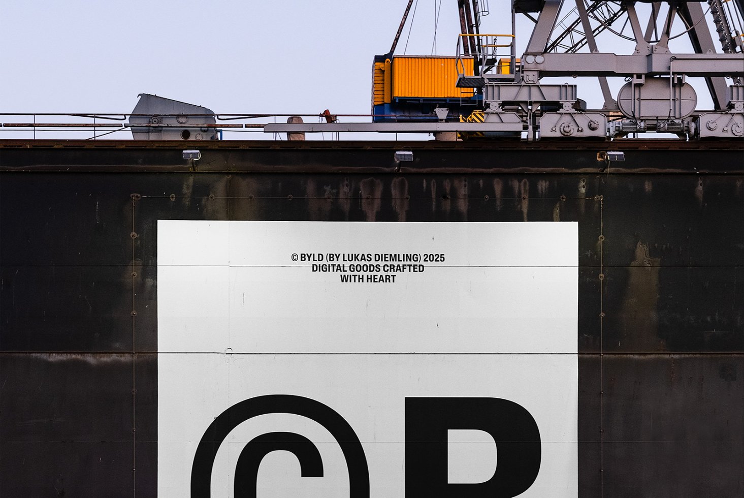 Industrial crane structure with a large copyright symbol on the side of a weathered ship. Perfect for mockups and graphic templates for designers.
