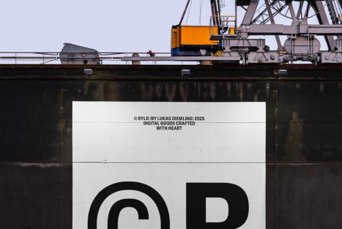 Industrial crane structure with a large copyright symbol on the side of a weathered ship. Perfect for mockups and graphic templates for designers.
