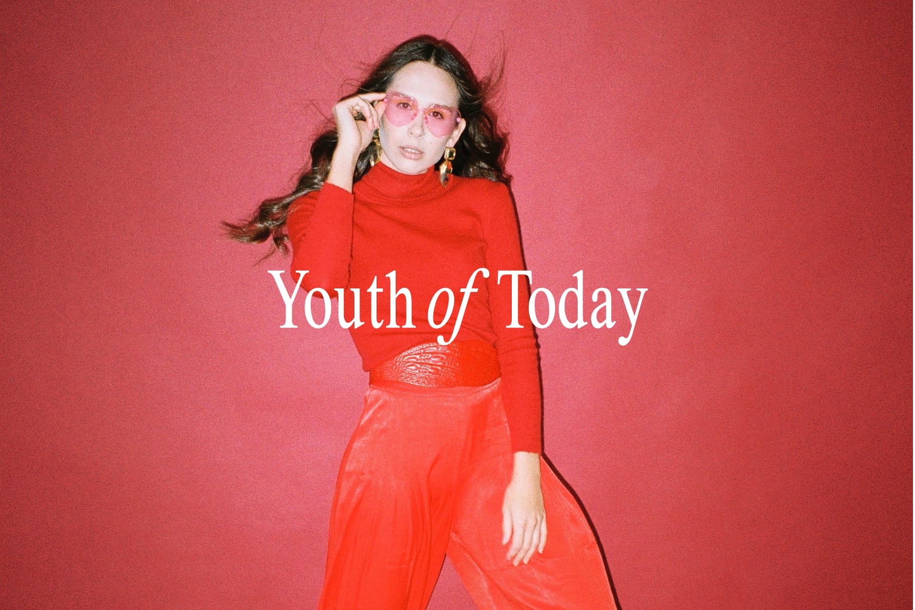Woman in red turtleneck with pink sunglasses against coral backdrop with Youth of Today text overlay