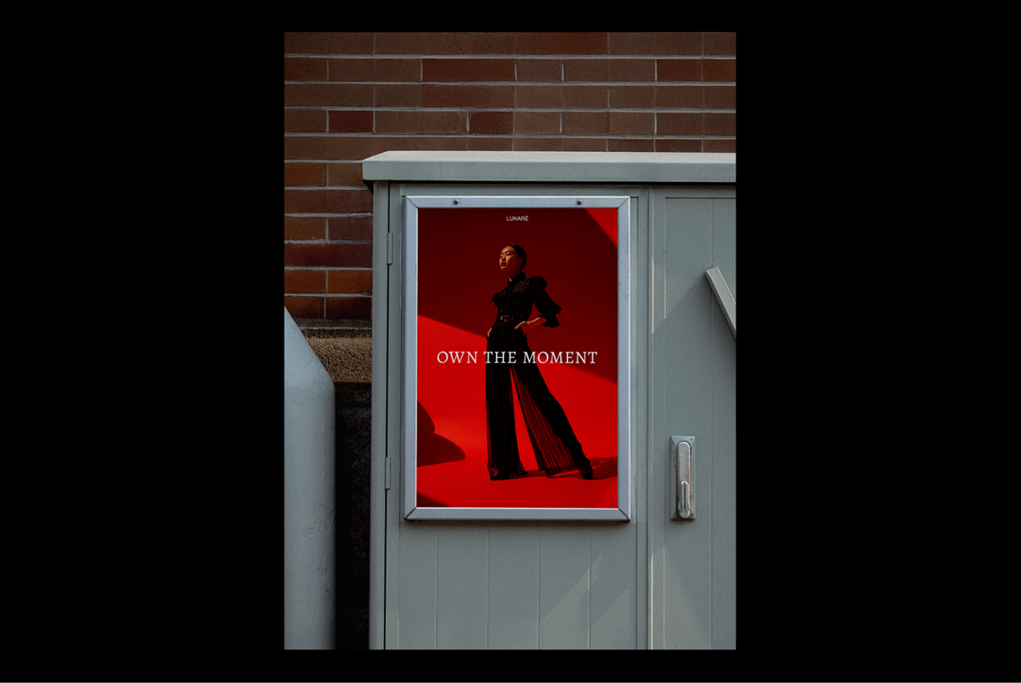 Street poster design with bold red background featuring fashion model and text Own The Moment ideal for graphic designers seeking mockup assets.