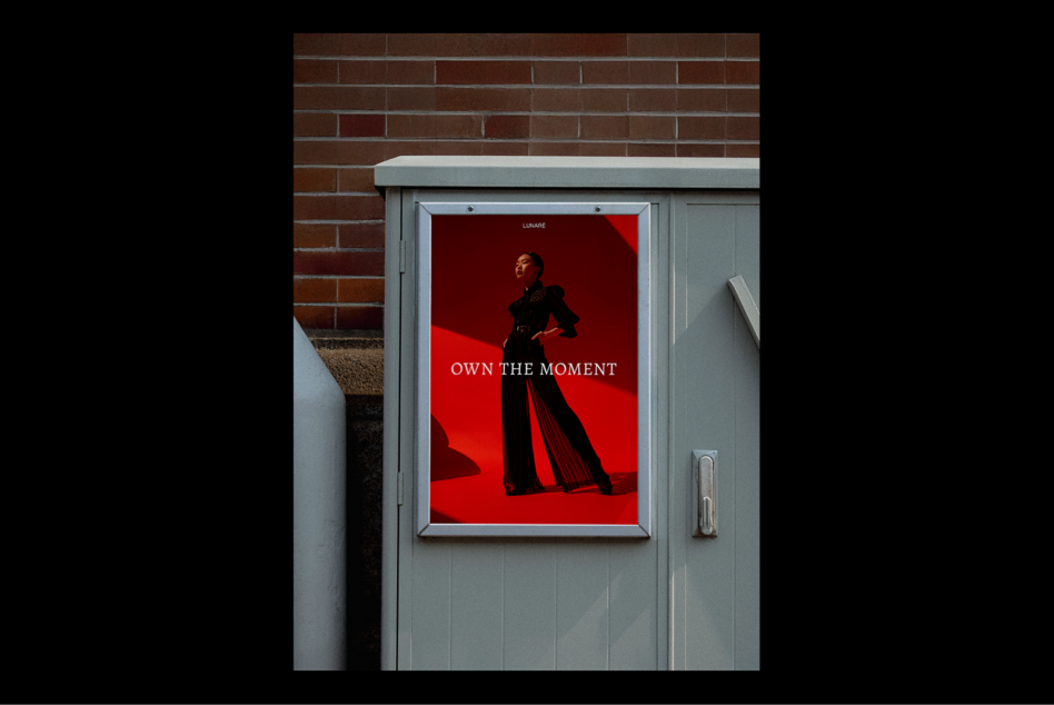 Street poster design with bold red background featuring fashion model and text Own The Moment ideal for graphic designers seeking mockup assets.