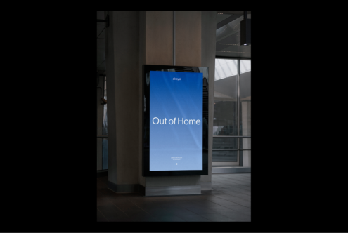 Digital billboard mockup in urban setting with blue screen displaying Out of Home text ideal for designers showcasing advertising designs and concepts.