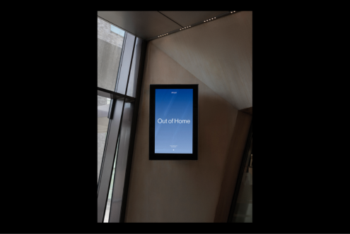 Digital poster mockup displayed in a modern building interior with natural light through windows perfect for designers focusing on advertising and signage.
