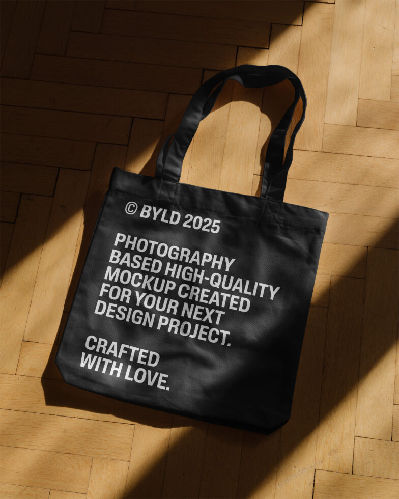 Tote bag mockup on wooden floor featuring white text highlighting high-quality design. Ideal for graphic designers or branding projects. Photography based.