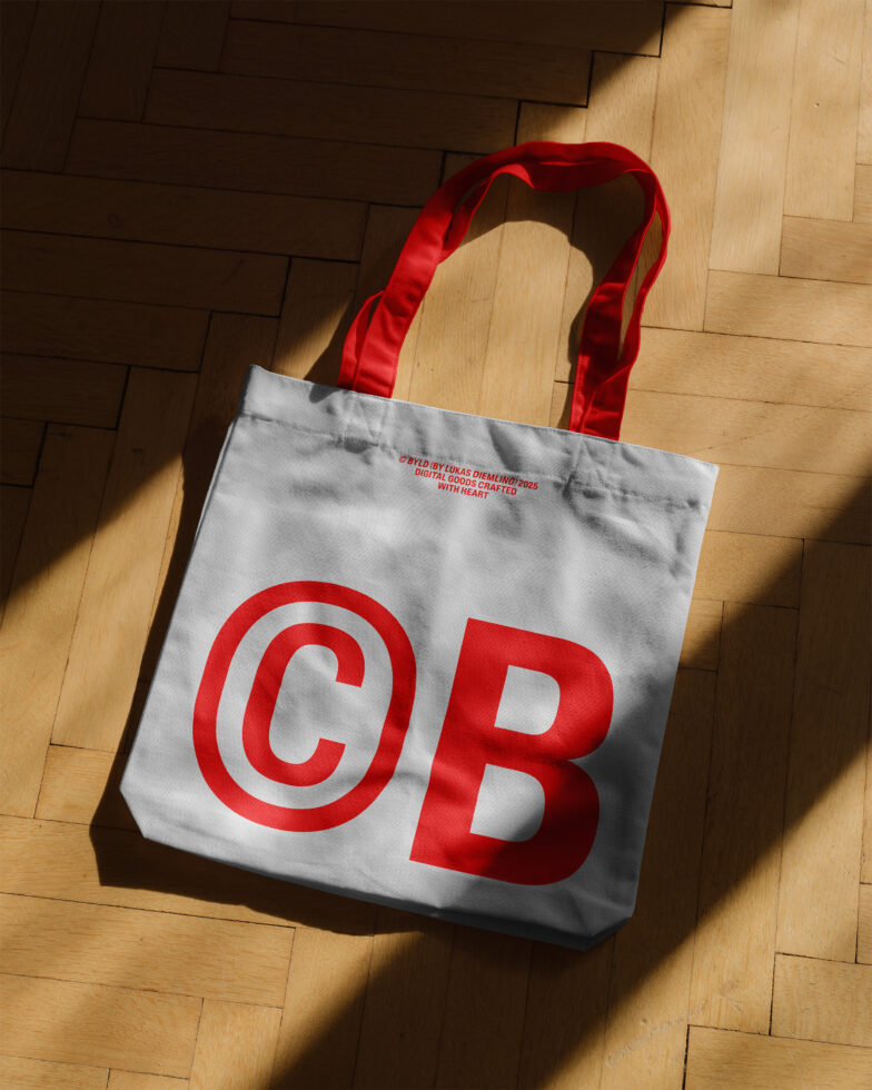 Tote bag mockup with bold red letters CB shadowed on wooden floor ideal for graphic designers branding template printable product design SEO.